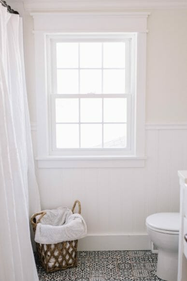 Farmhouse Bathroom Makeover // Bathroom Renovation Ideas with sliding barn door, medicine cabinets & black and white tile floors