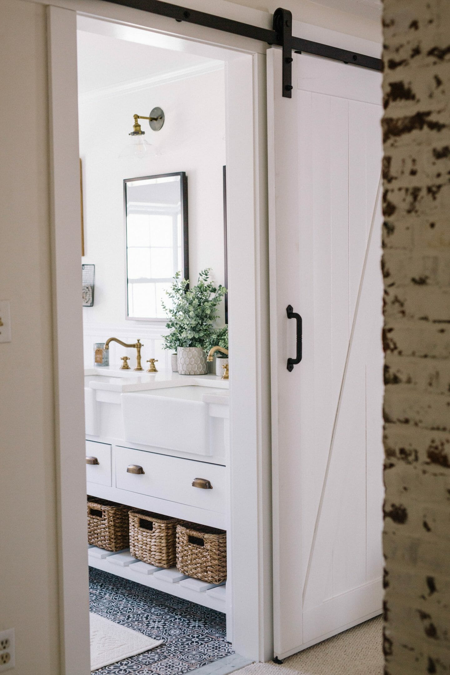 Farmhouse Bathroom Makeover // Bathroom Renovation Ideas with sliding barn door, medicine cabinets & black and white tile floors